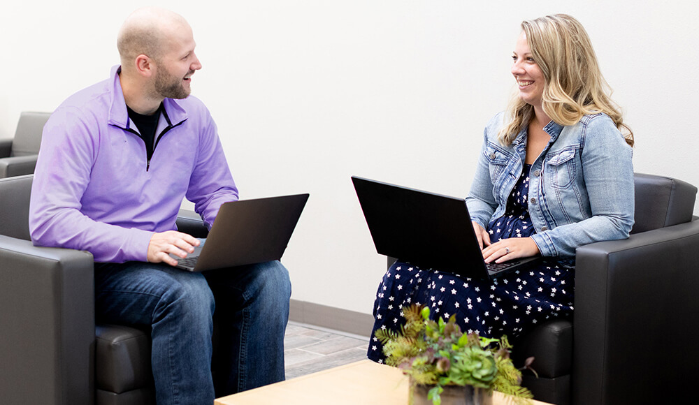 Man and woman meeting with laptops