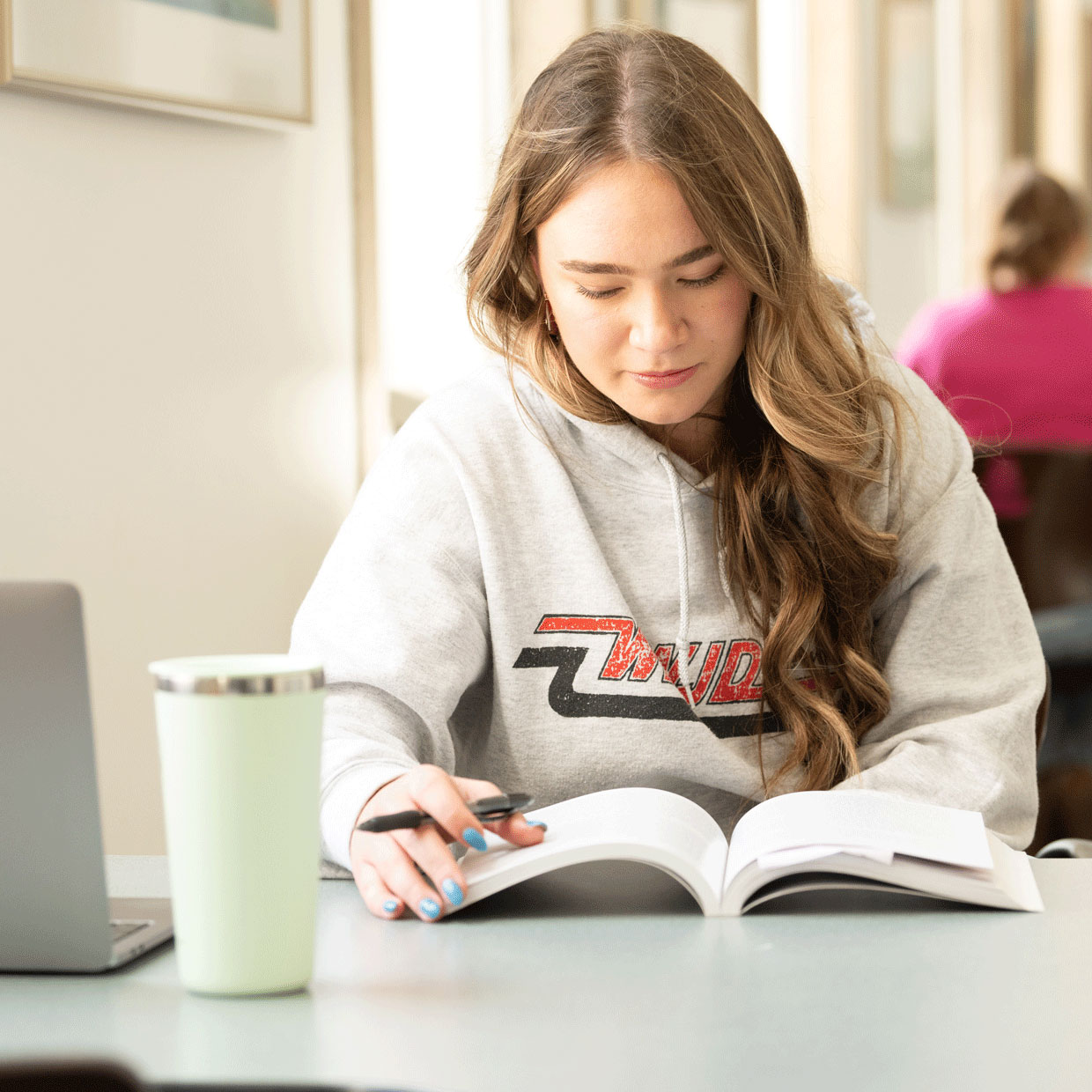 Female student reading textbook