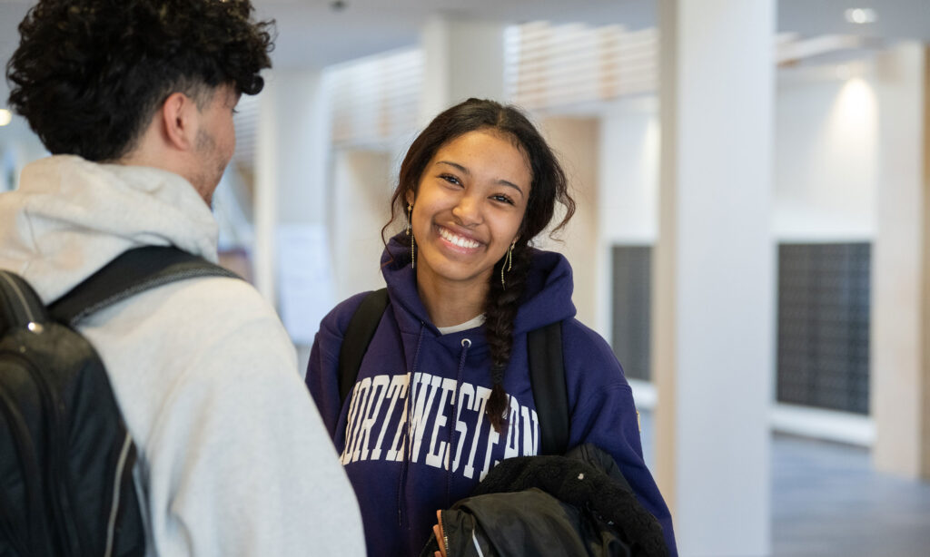 Female Student smiling in Northwestern sweatshirt.
