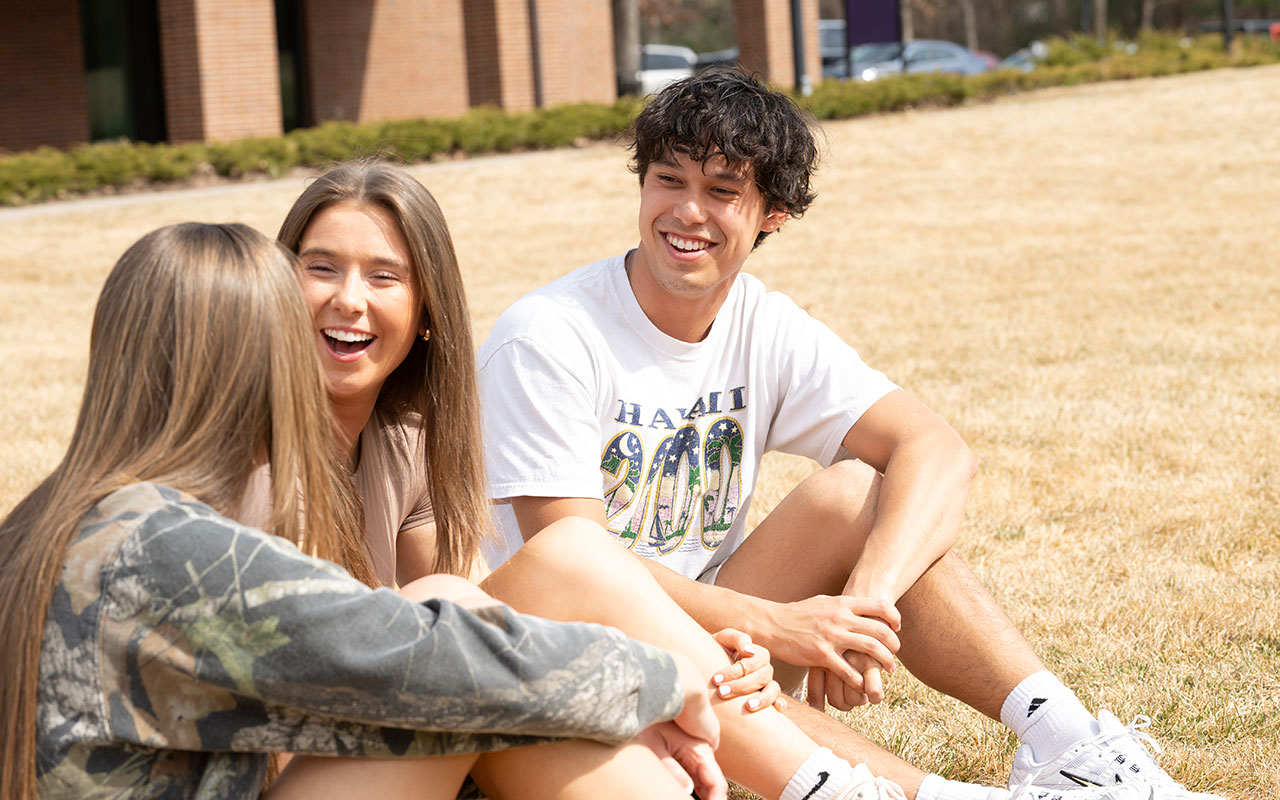 Students-sitting-on-campus-green