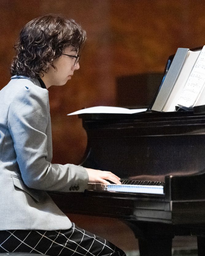 Student playing Piano in Naz Chapel.