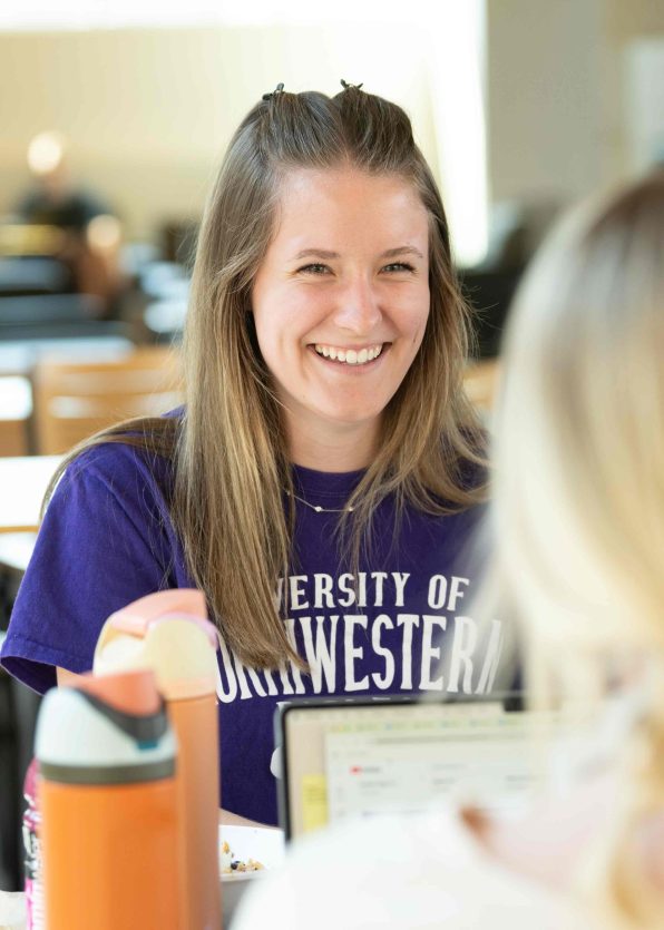 Student sitting in the Billy, smiling.