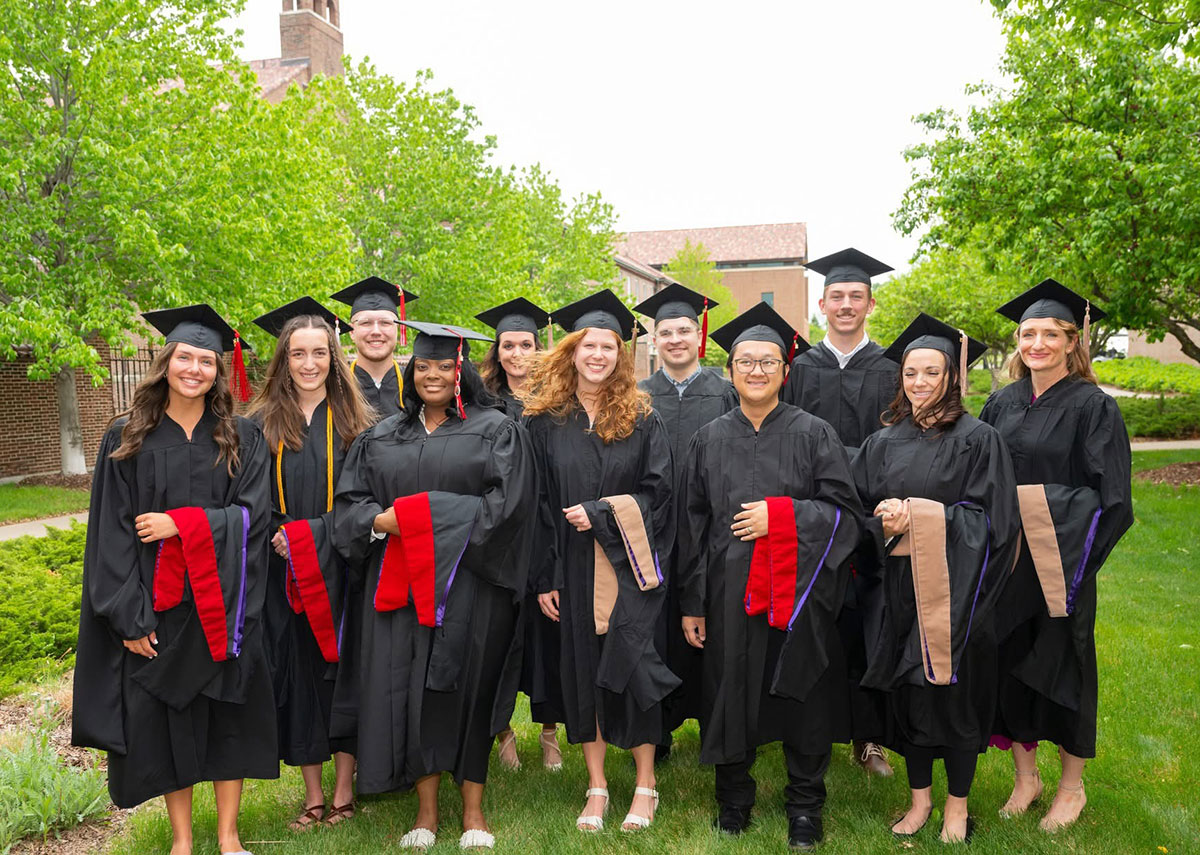 Graduate students standing outside at Graduation.