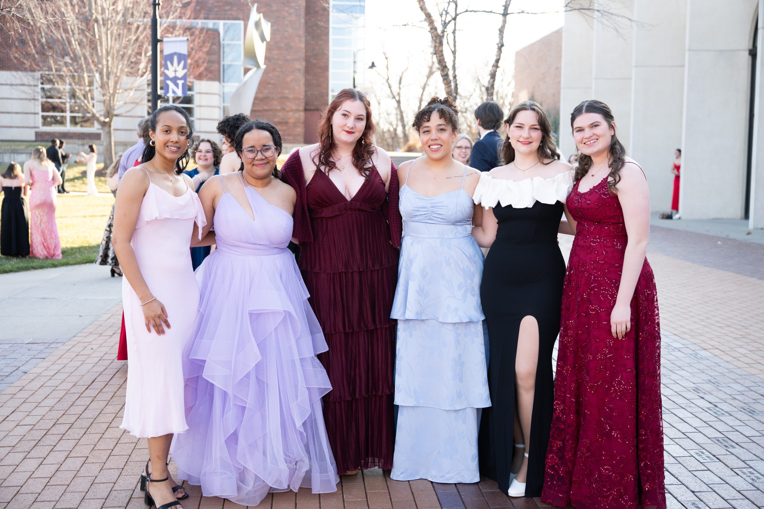 Students posing in front of Totino Fine Arts Center at Five16.