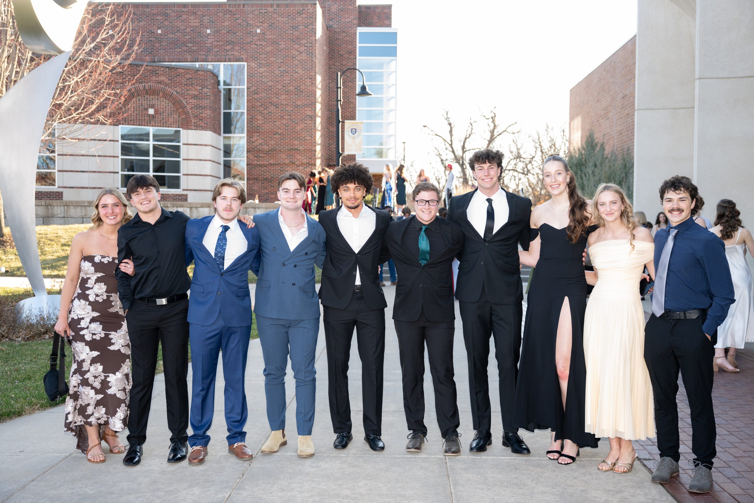 Students posing in front of Totino Fine Arts Center at Five16.
