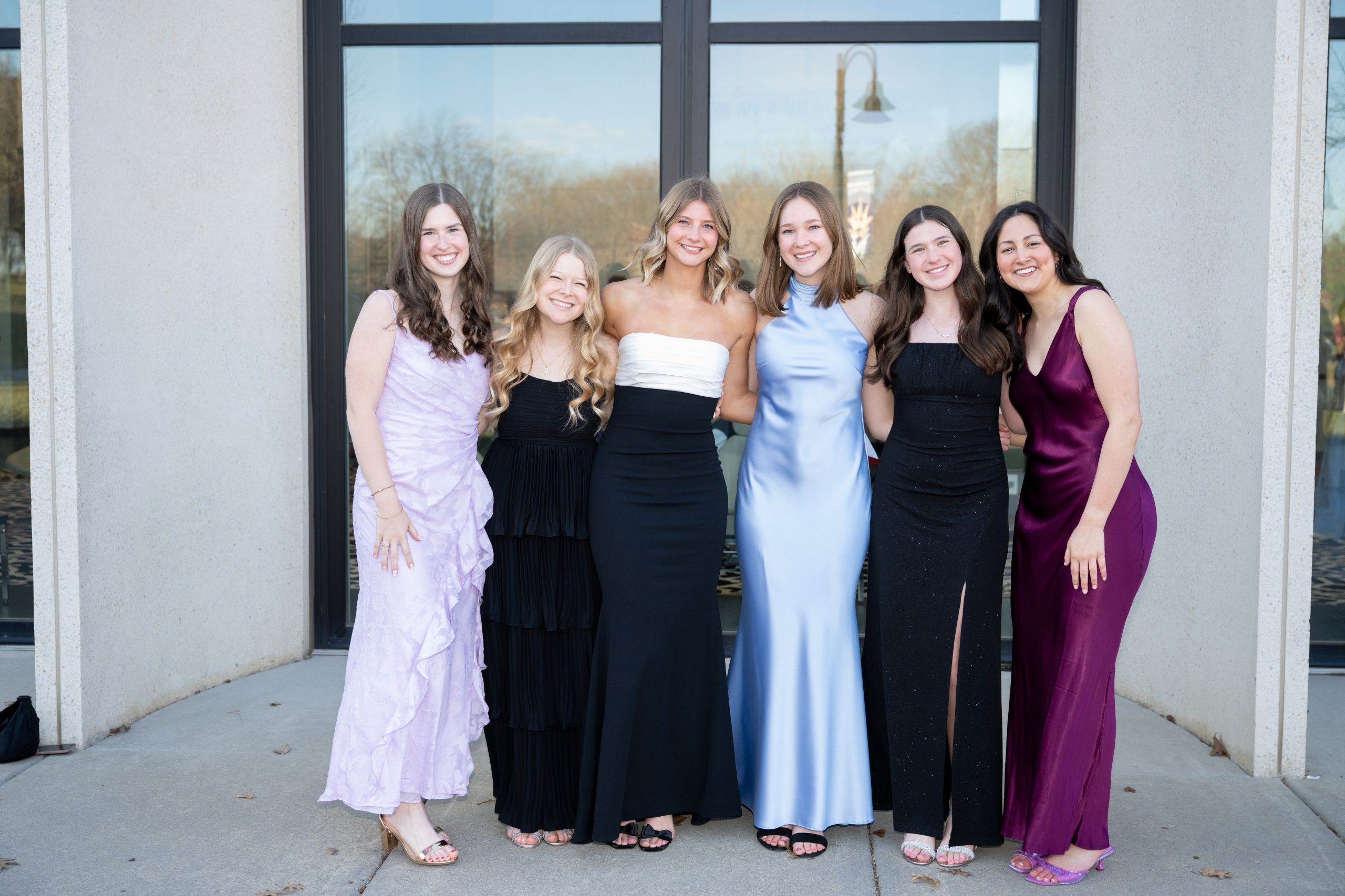 Students posing in front of Totino Fine Arts Center at Five16.