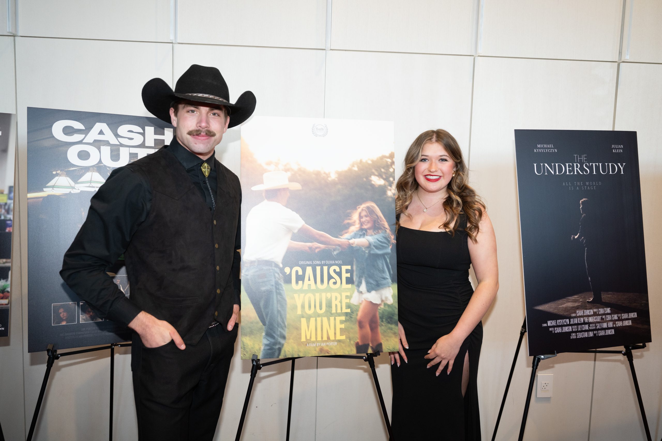 Students posing beside their movie poster.