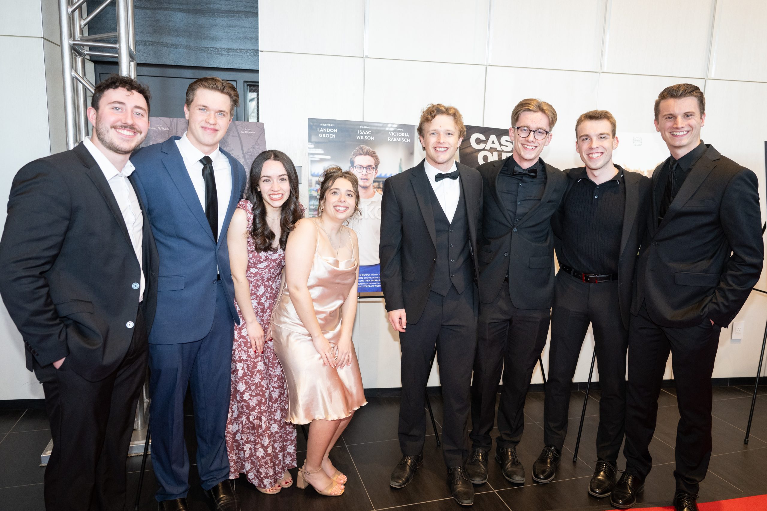 Students posing in front of their movie poster at Five16.