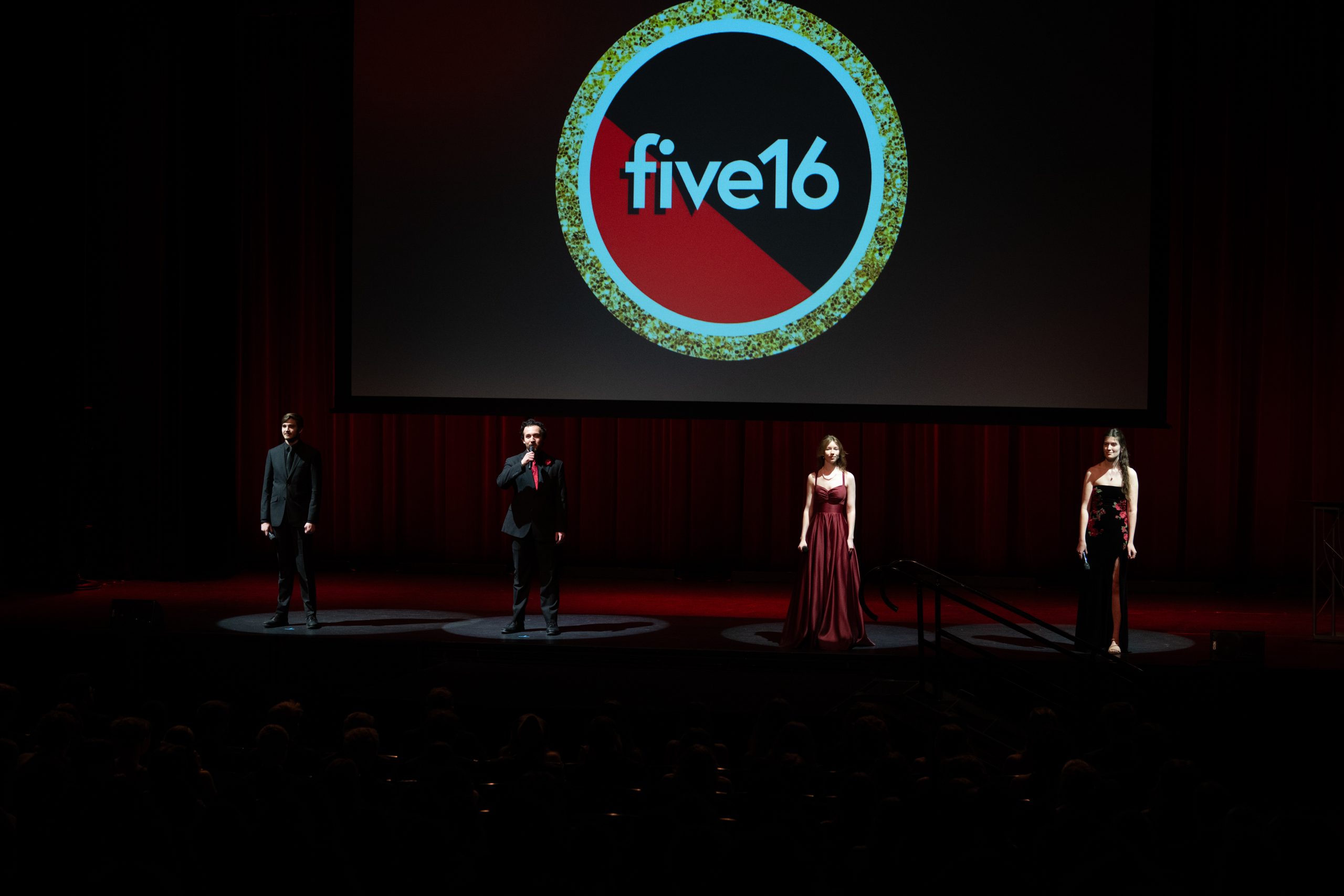 Students speaking on stage at the beginning of Five16 to open the night.