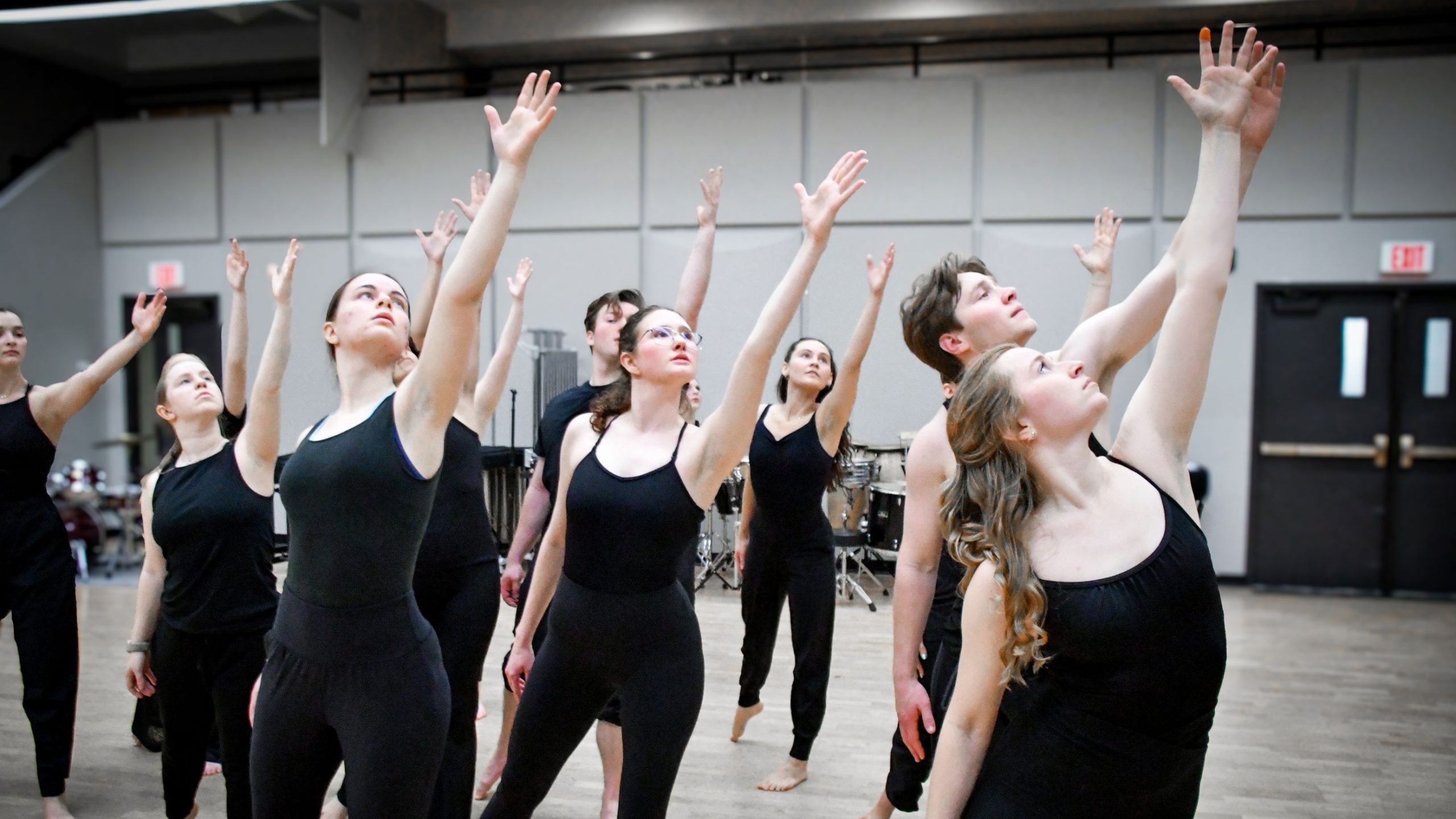 Dance students running through a dance in the practice room.