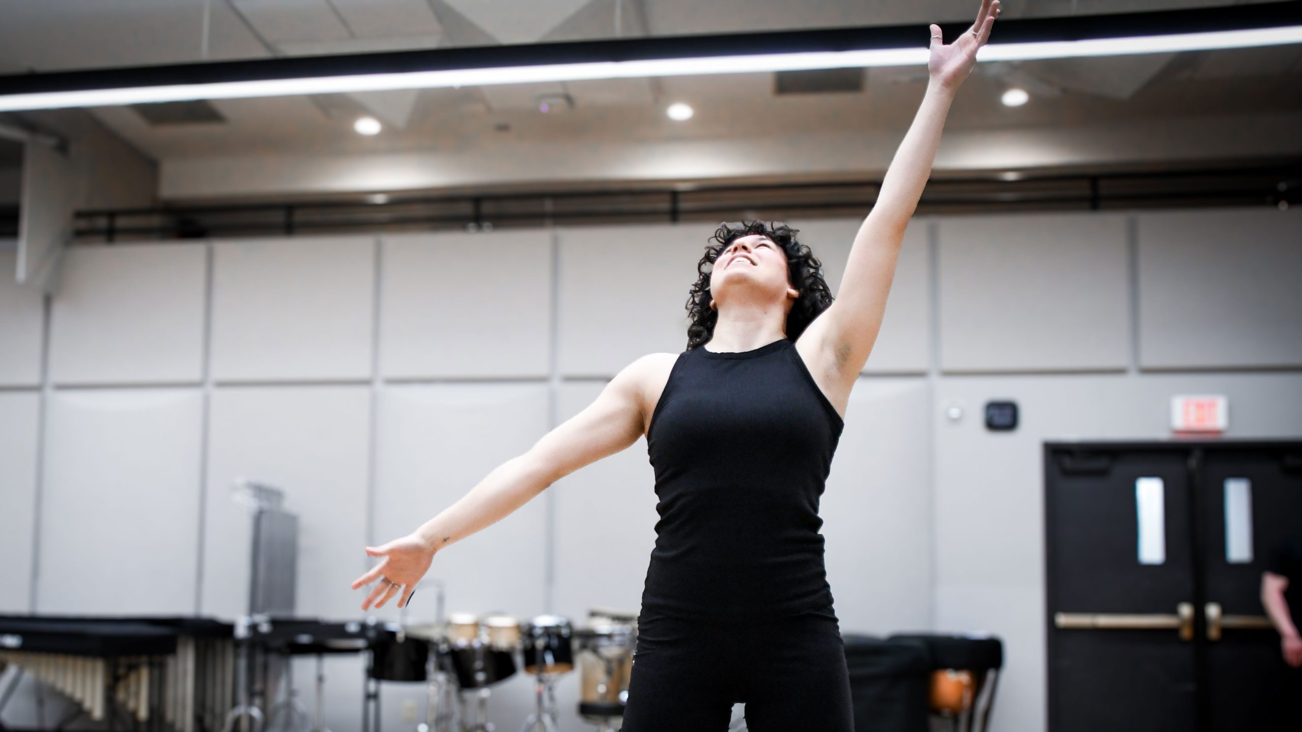 Dance student mid-pose stretching for the ceiling.