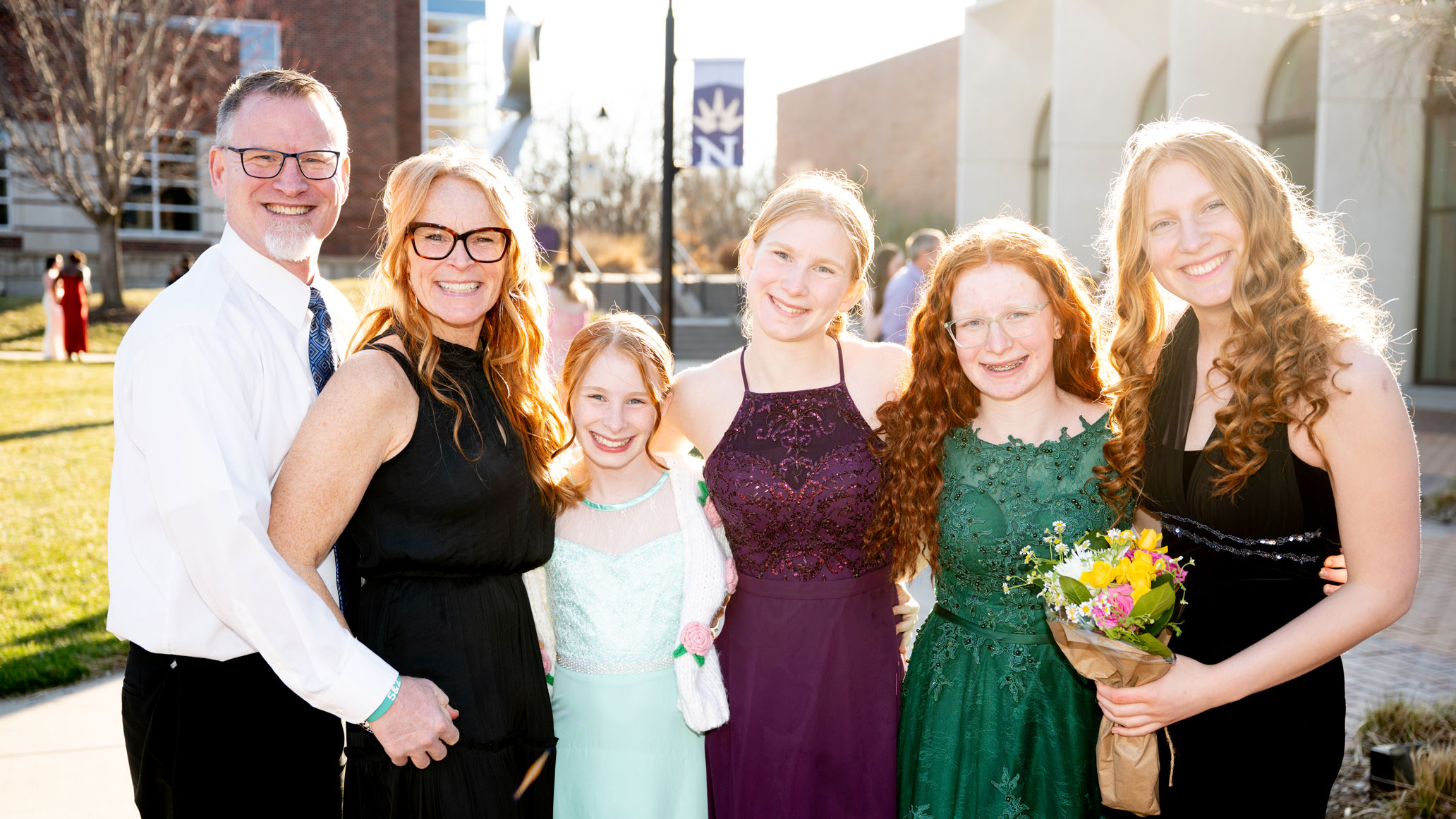 Family Posing in front of Totino dressed in formalwear for Five16.