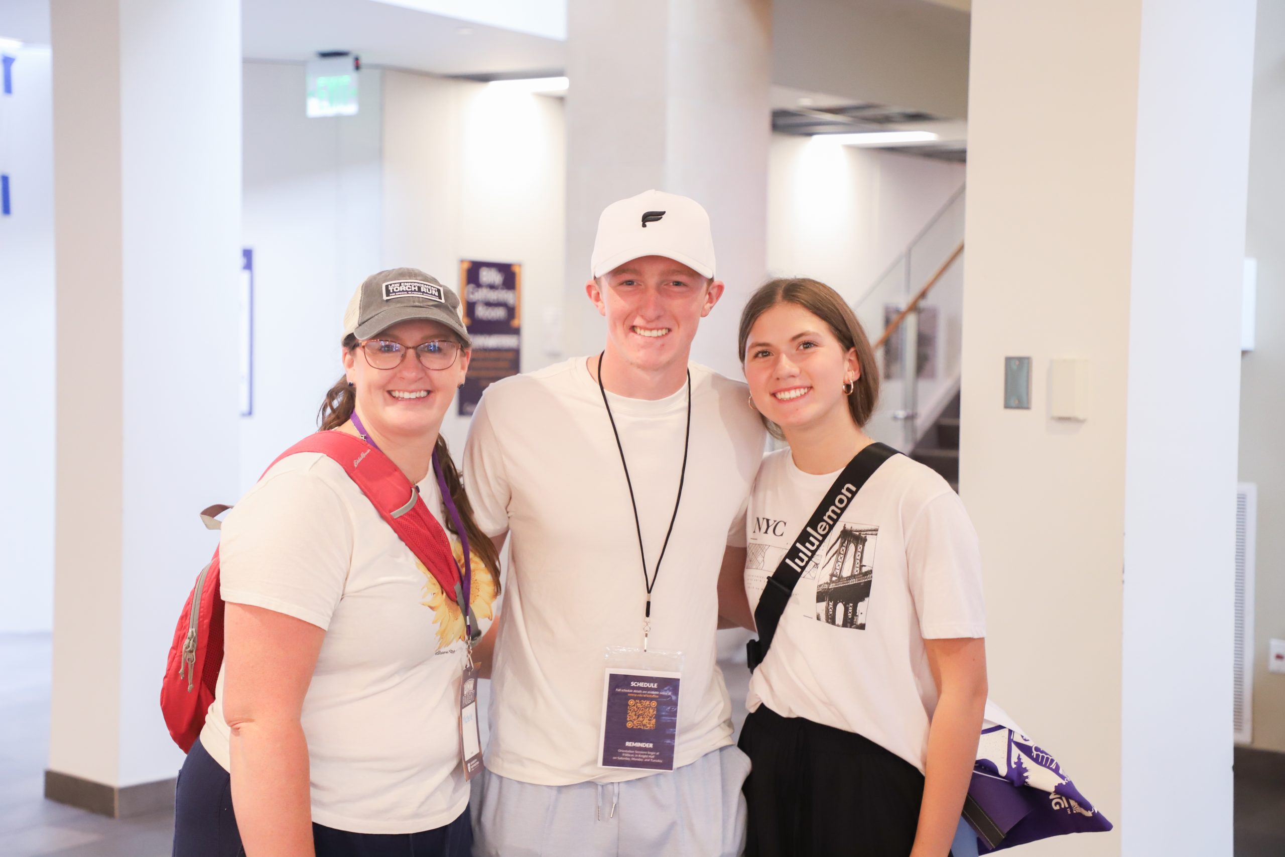 Two new students with their parent on move-in day.