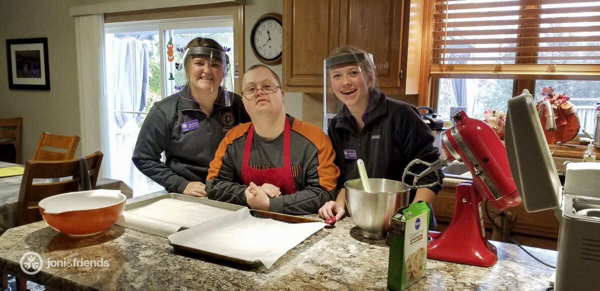 Nursing students and resident baking together